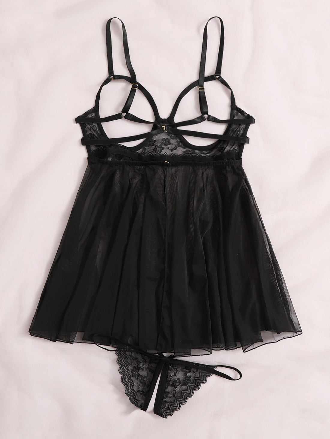 Women's black sheer mesh babydoll lingerie set with cut-out detail, adjustable spaghetti straps, triangle cups, and matching low-rise thong.