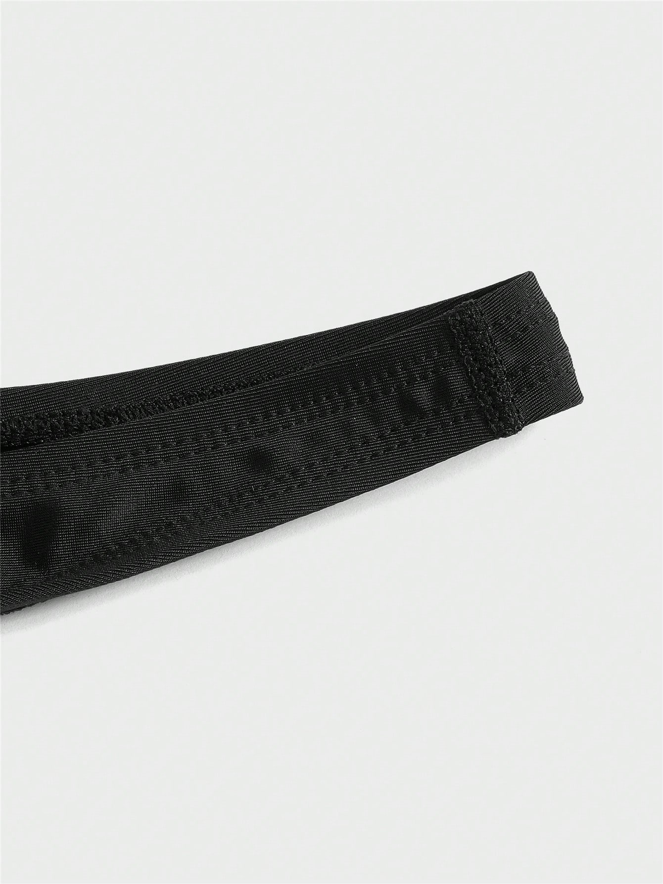 Black men's plain swim briefs with cut-out detail, high waist, short length, and high-stretch polyester elastane fabric.