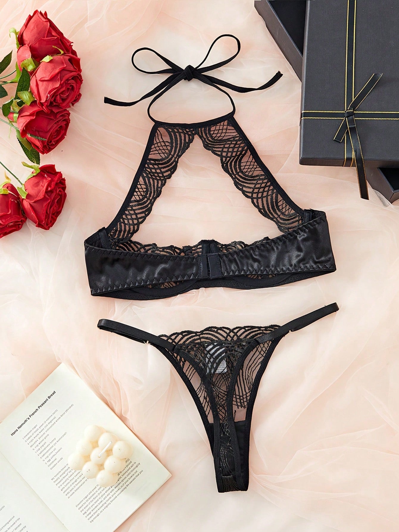 Black sheer embroidered 2-piece women's lingerie set with halter-style adjustable straps, underwire bralette, cut-out details, and matching low-rise thong.