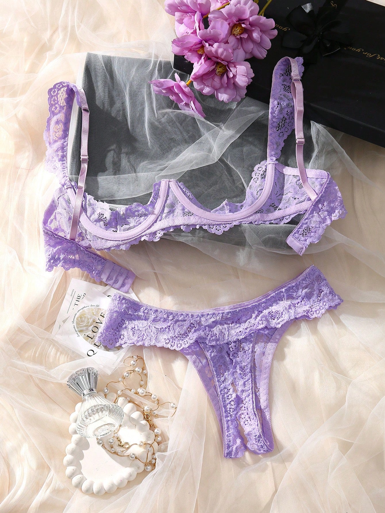 Women's sheer lace underwire bra and thong set with open cup bra, adjustable spaghetti straps, and matching low rise V-string thong in a 2-piece lingerie set.