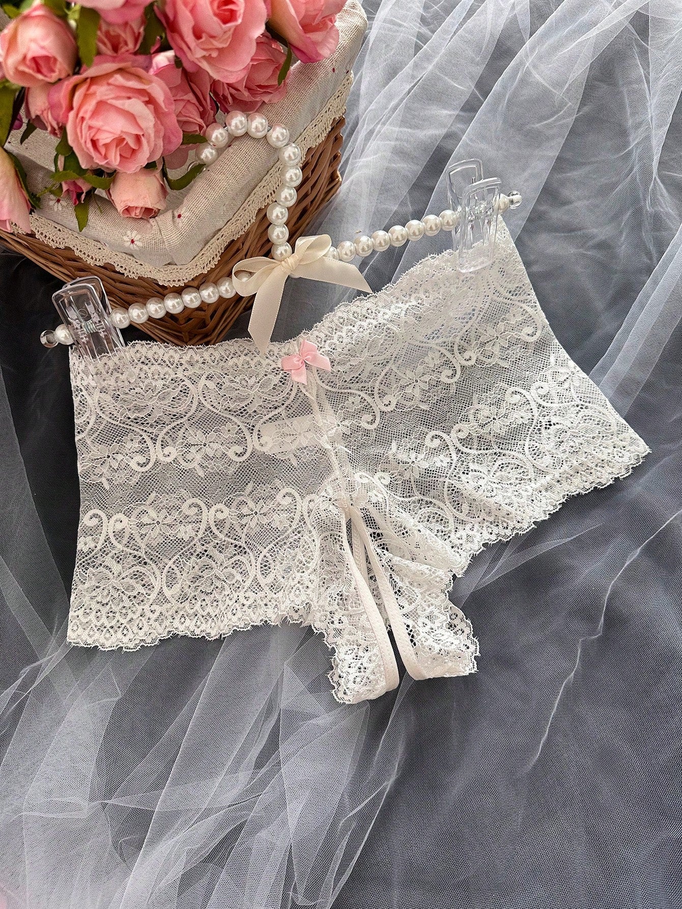 Black women's crotchless lace briefs with a mid-rise fit, textured pattern, cut-out split detail, and slight-stretch romantic styling.