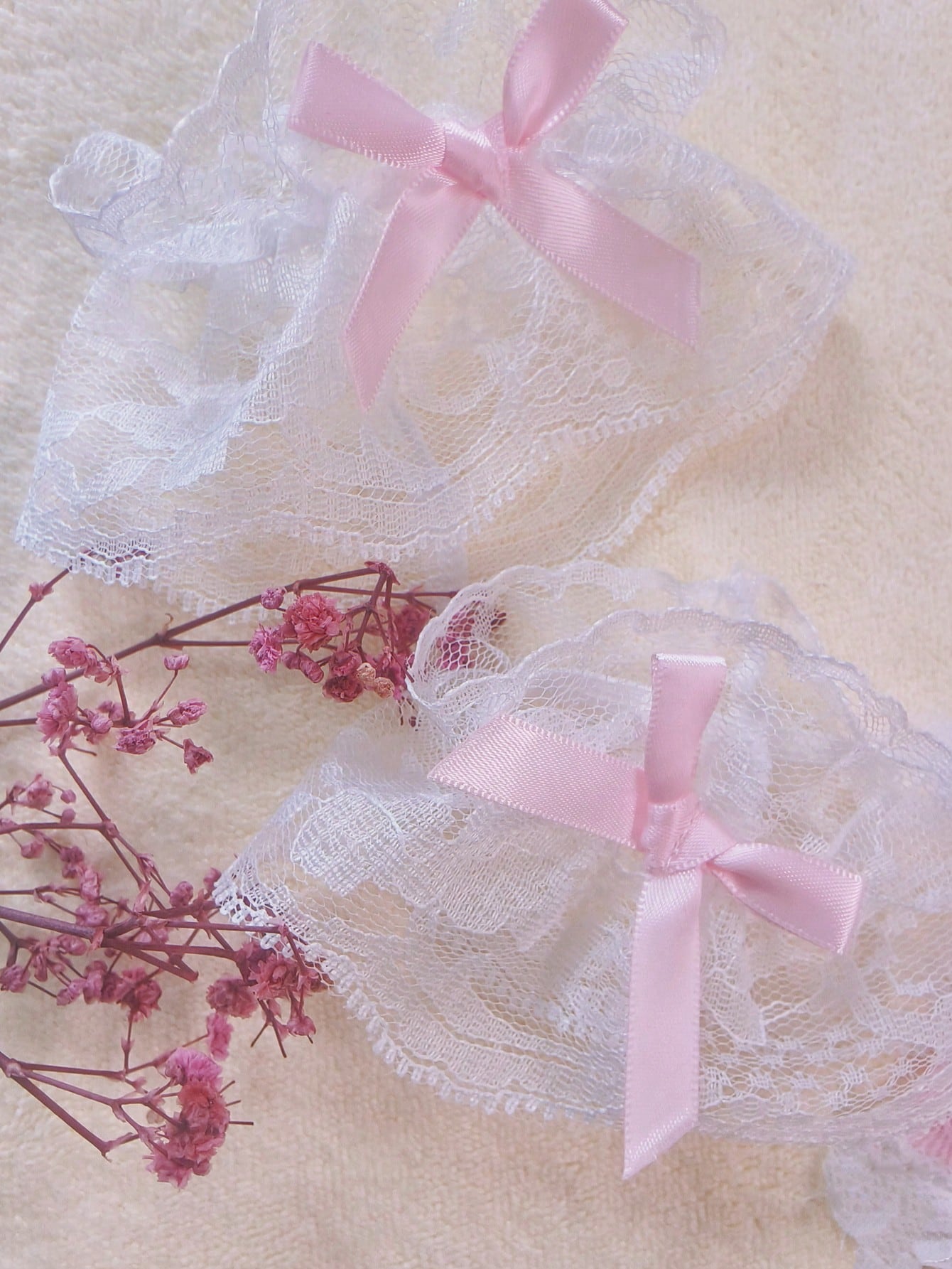 Pink lace bodystocking lingerie set for women with adjustable spaghetti straps, bow detail, contrast faux fur trim, matching headpiece, armband, stockings, and thong.