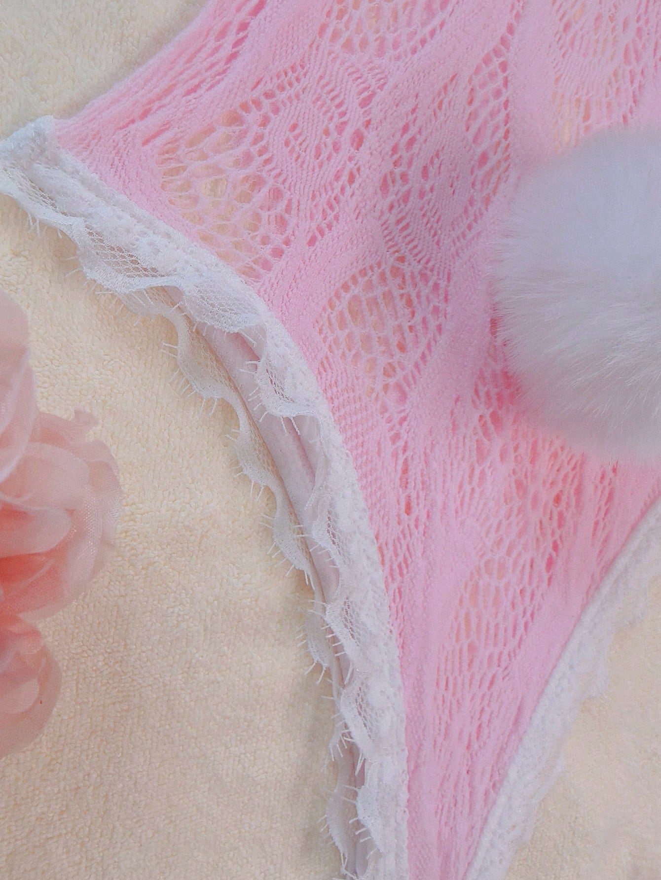 Pink lace bodystocking lingerie set for women with adjustable spaghetti straps, bow detail, contrast faux fur trim, matching headpiece, armband, stockings, and thong.
