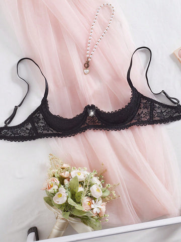 Women's semi-sheer black lace underwire bra with adjustable spaghetti straps, contrast lace detail, 1/2 cup design, and pullover fit.