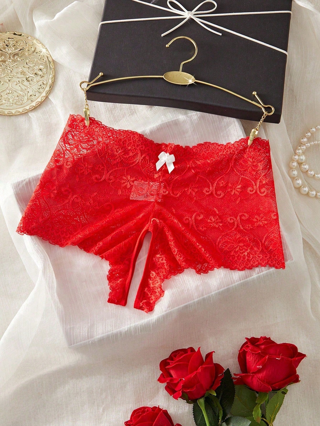 Black women's crotchless lace briefs with a mid-rise fit, textured pattern, cut-out split detail, and slight-stretch romantic styling.