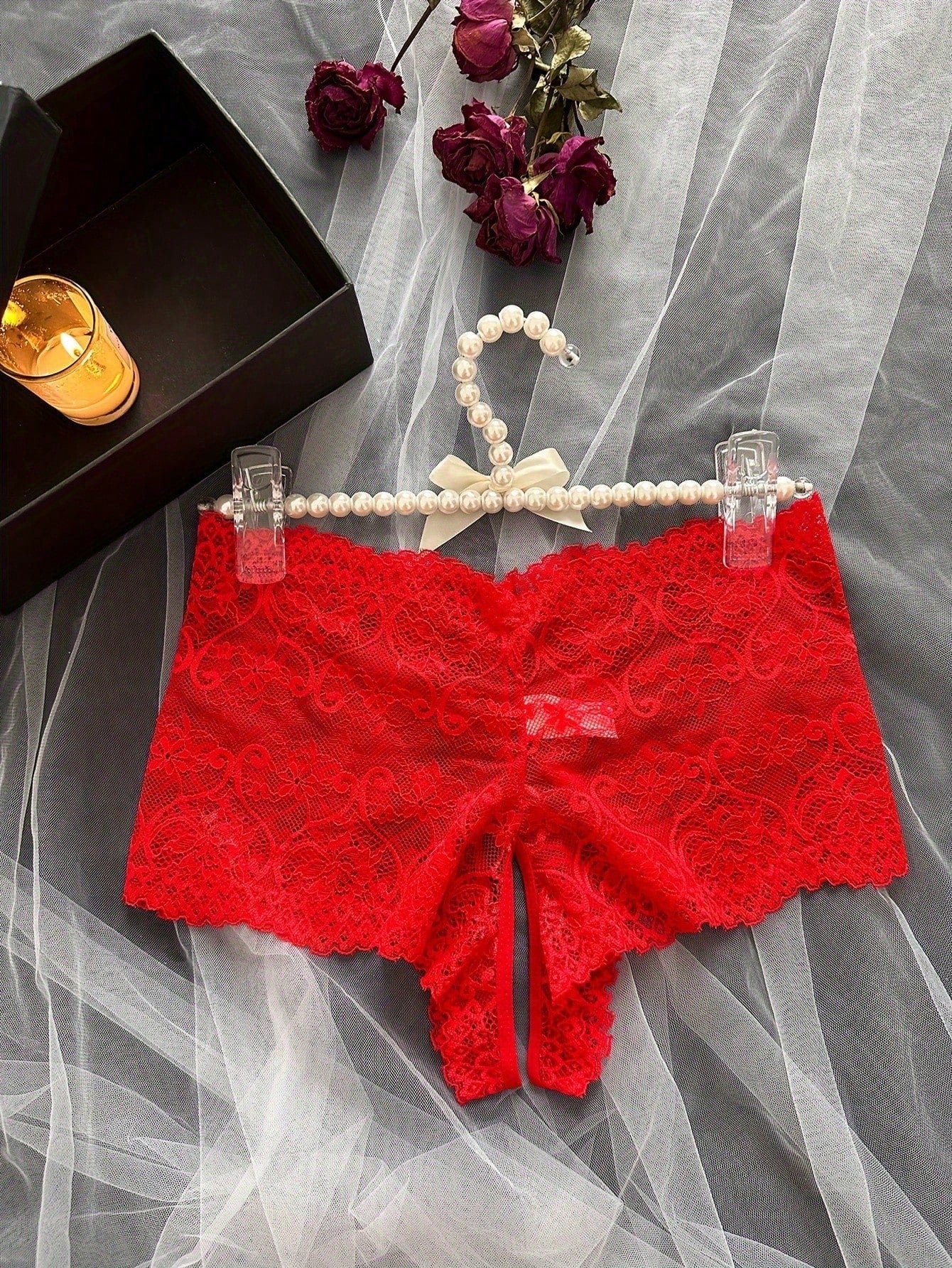 Black women's crotchless lace briefs with a mid-rise fit, textured pattern, cut-out split detail, and slight-stretch romantic styling.