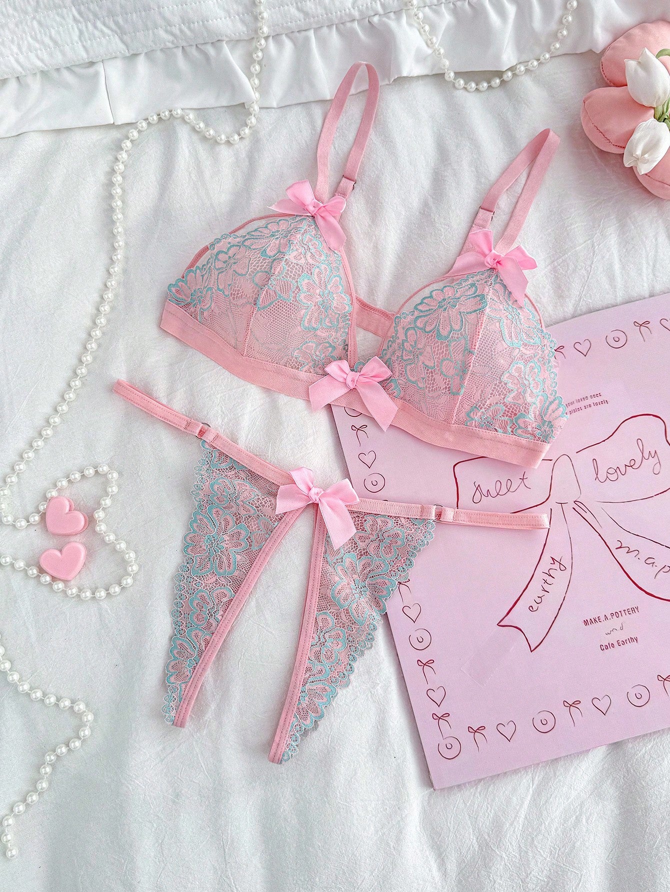 Sheer pink knitted lingerie set for women with a wireless triangle bralette, adjustable spaghetti straps, bow detail, backless design, and matching low-rise briefs.