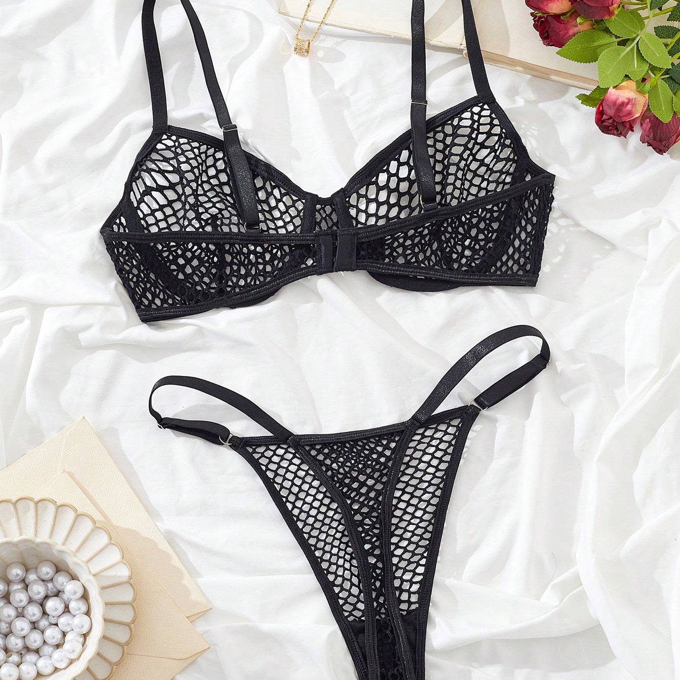 Women's 2-piece mesh lingerie set with hollow out detail, underwire bra, adjustable spaghetti straps, and matching low-rise thong panties in a sheer plain design.