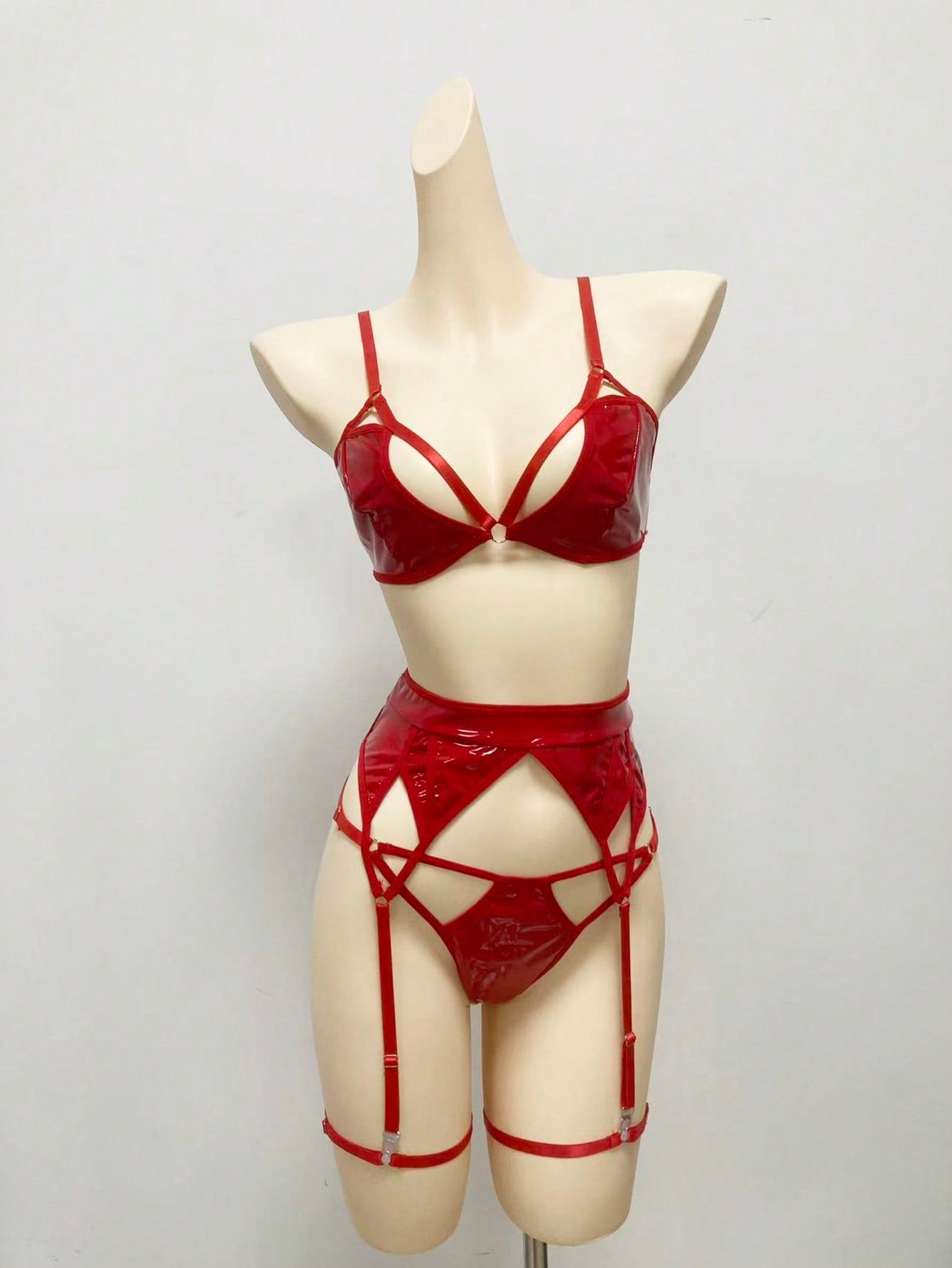 Women's 4-piece wireless lingerie set with cut-out bralette, adjustable spaghetti straps, V-string panty, and matching body accessories in plain style.