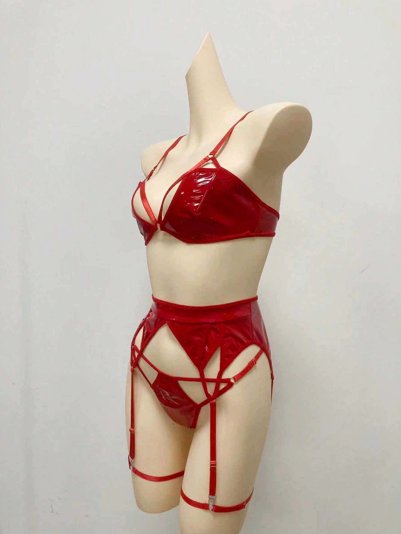 Women's 4-piece wireless lingerie set with cut-out bralette, adjustable spaghetti straps, V-string panty, and matching body accessories in plain style.