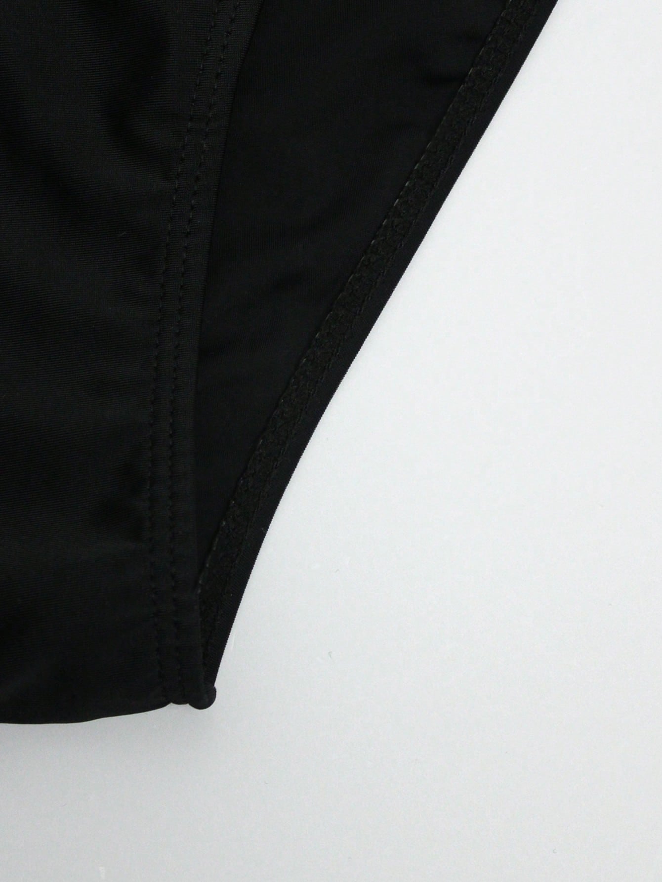 Men's solid swim briefs with O-ring detail, high waist, short racer cut, and high-stretch polyamide elastane fabric.