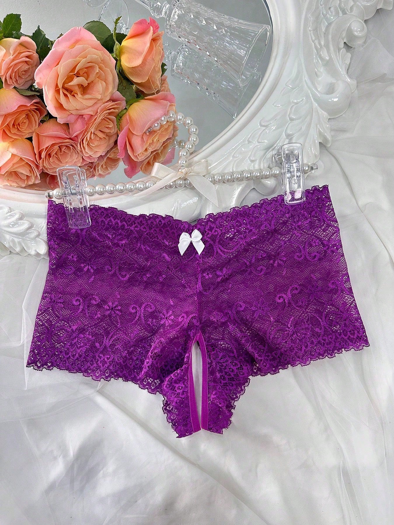 Black women's crotchless lace briefs with a mid-rise fit, textured pattern, cut-out split detail, and slight-stretch romantic styling.