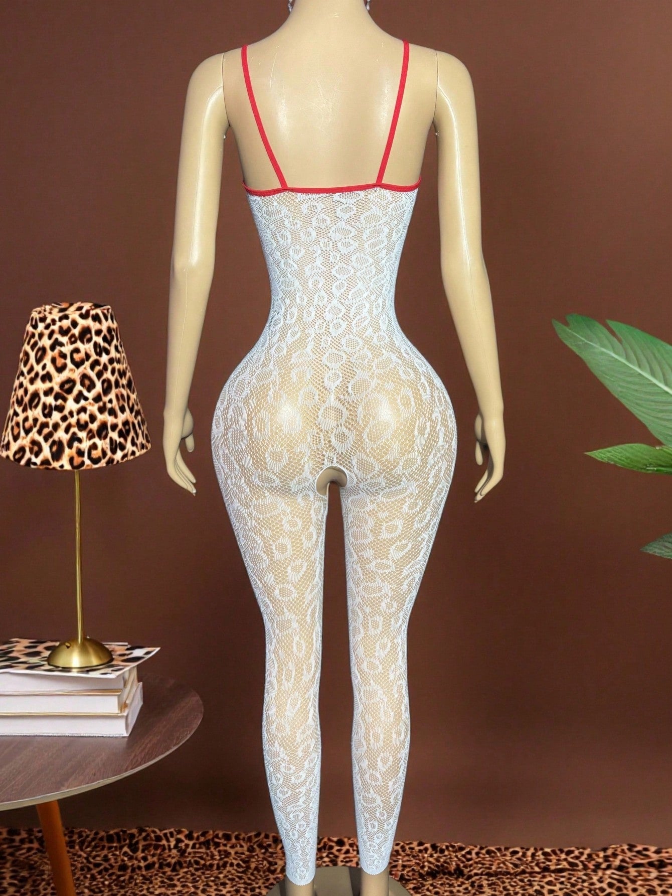 Sleeveless pink lingerie bodysuit 2 piece set with sheer textured fabric, backless design, contrast lace, knot detail, adjustable spaghetti straps, and cropped low rise fit.