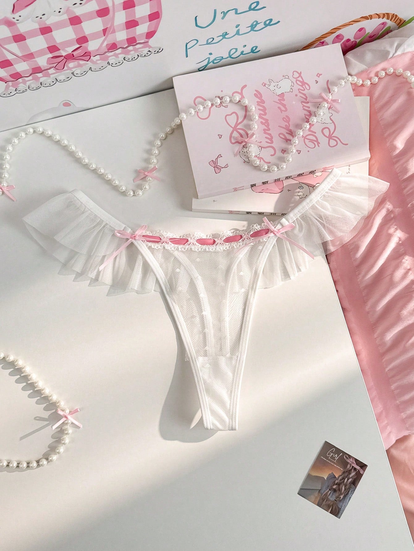 Women's ruffled mesh thong panty with bow detail and mid rise fit, plain design, 1-piece style