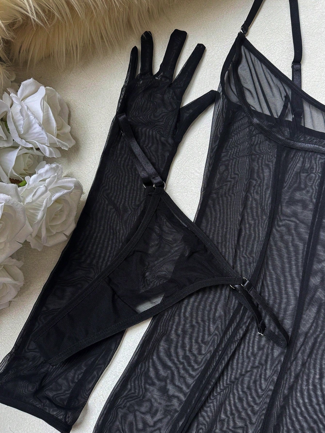 Women's black sheer mesh lingerie set with adjustable spaghetti straps, wireless design, V-string panty, garter belt, and matching gloves