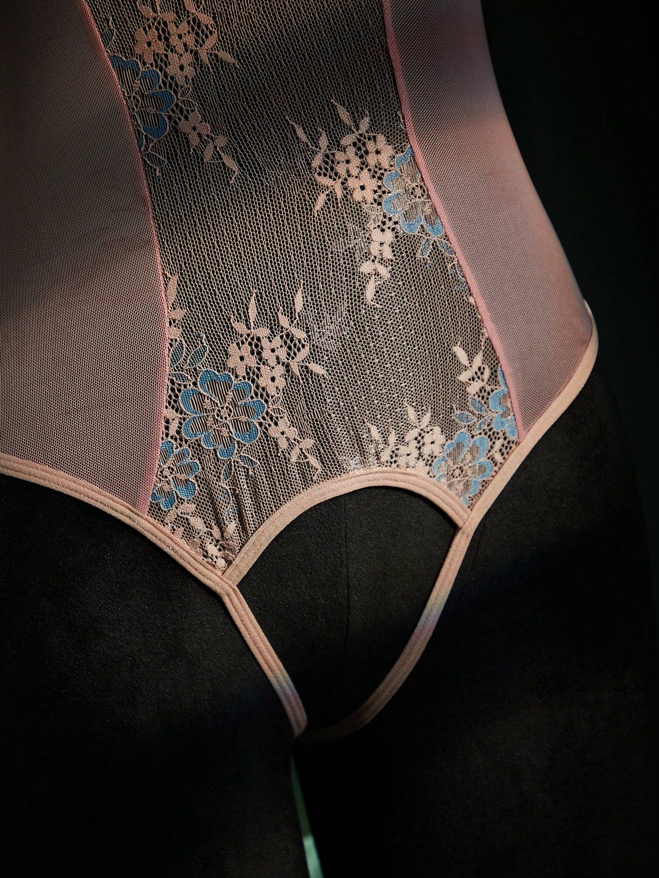 Women's sheer underwire bodysuit teddy in mesh fabric with contrast lace, cut-out detail, adjustable spaghetti straps, and sleeveless design.