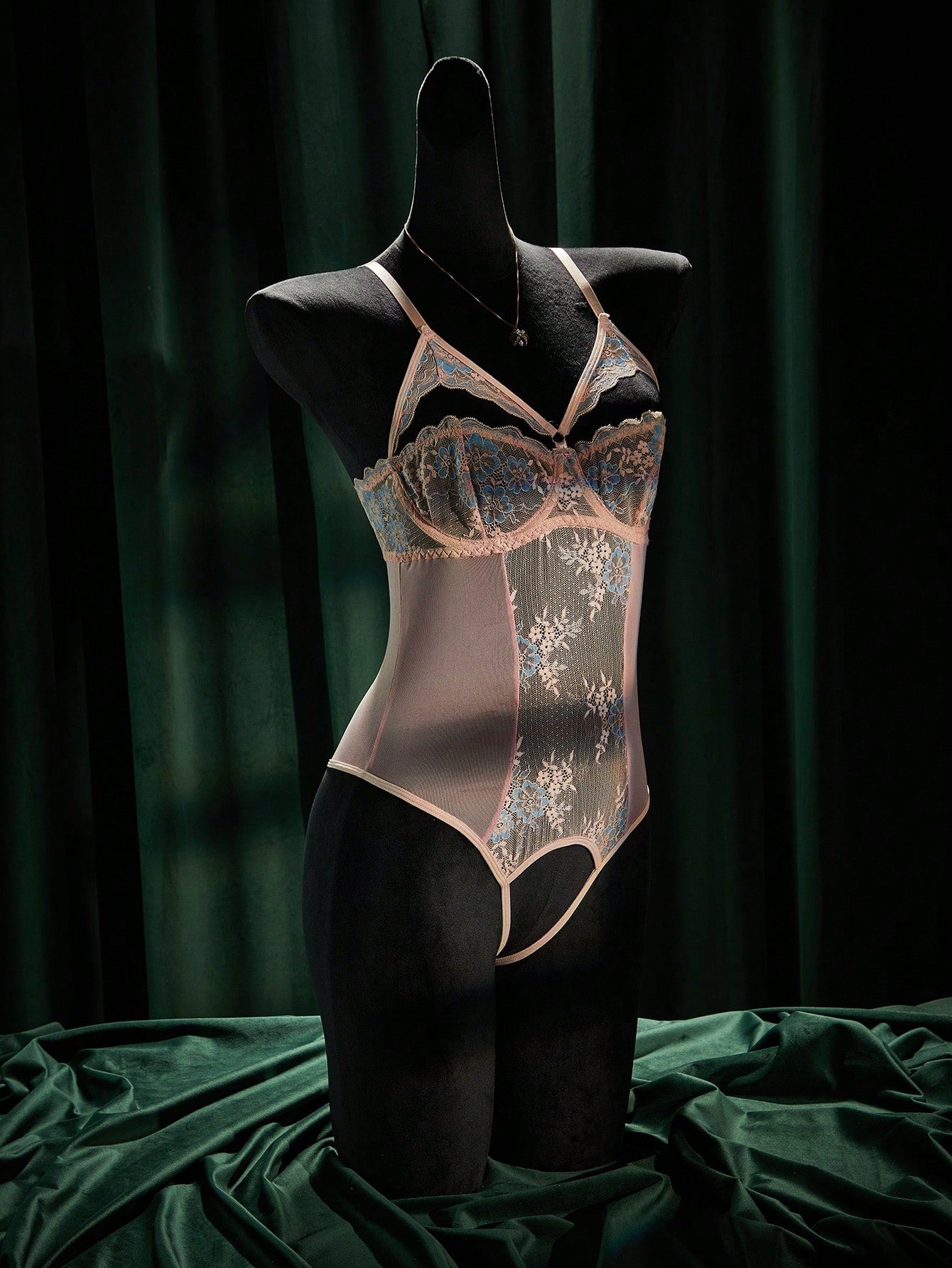 Women's sheer underwire bodysuit teddy in mesh fabric with contrast lace, cut-out detail, adjustable spaghetti straps, and sleeveless design.