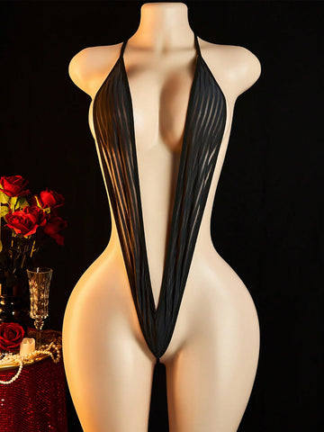Women's sheer black lace bodysuit with backless design, halter neckline, and wireless one-piece fit in medium-stretch knitted fabric.