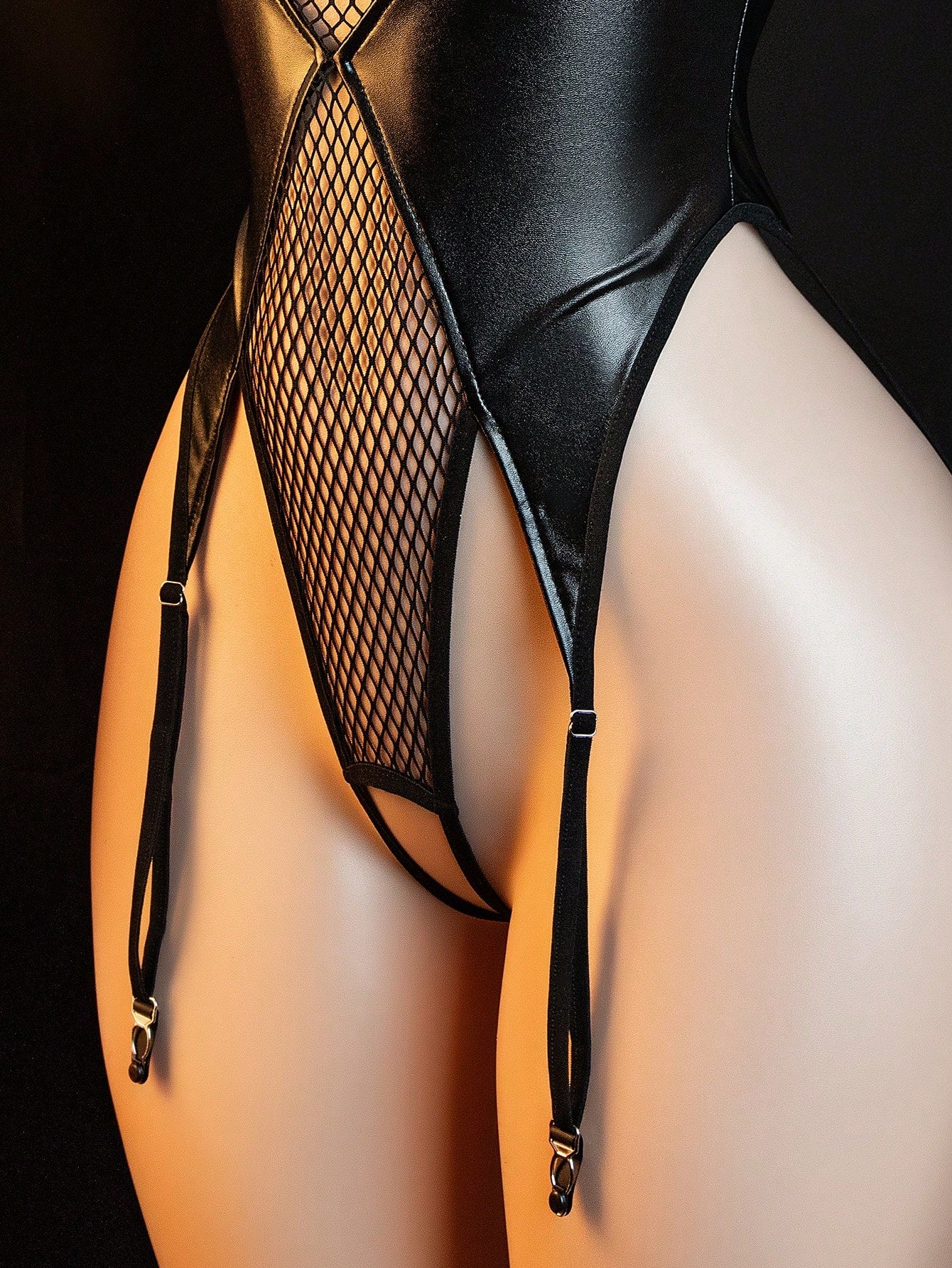 Black women's lingerie bodysuit set with backless lace-up design, strapless bandeau neckline, sheer knitted fabric, thong bottom, and matching headband.