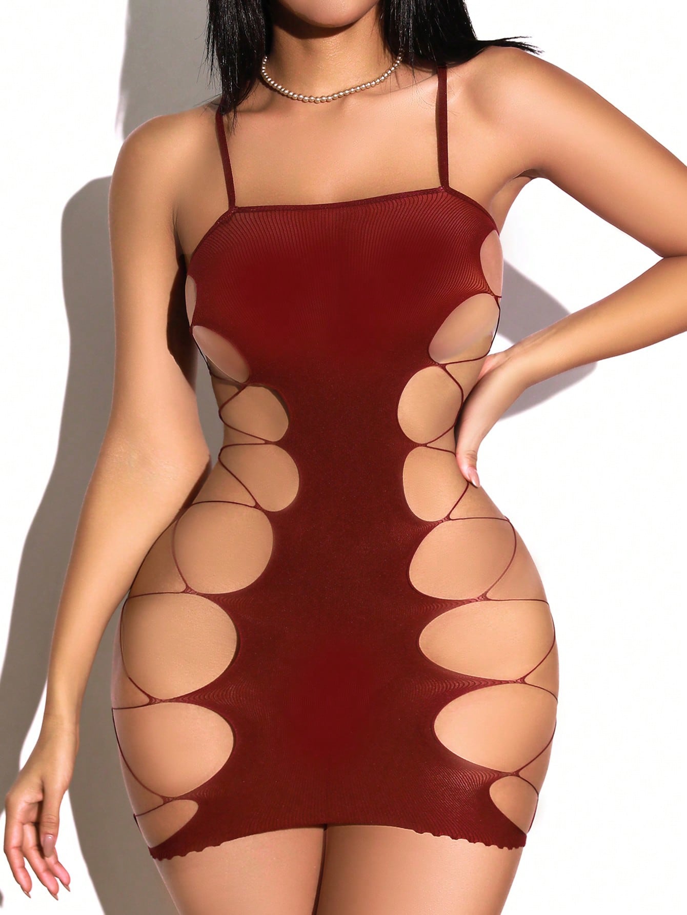Women's sheer mesh babydoll lingerie dress with cut-out detail, adjustable spaghetti straps, mini length, and high-stretch fabric.