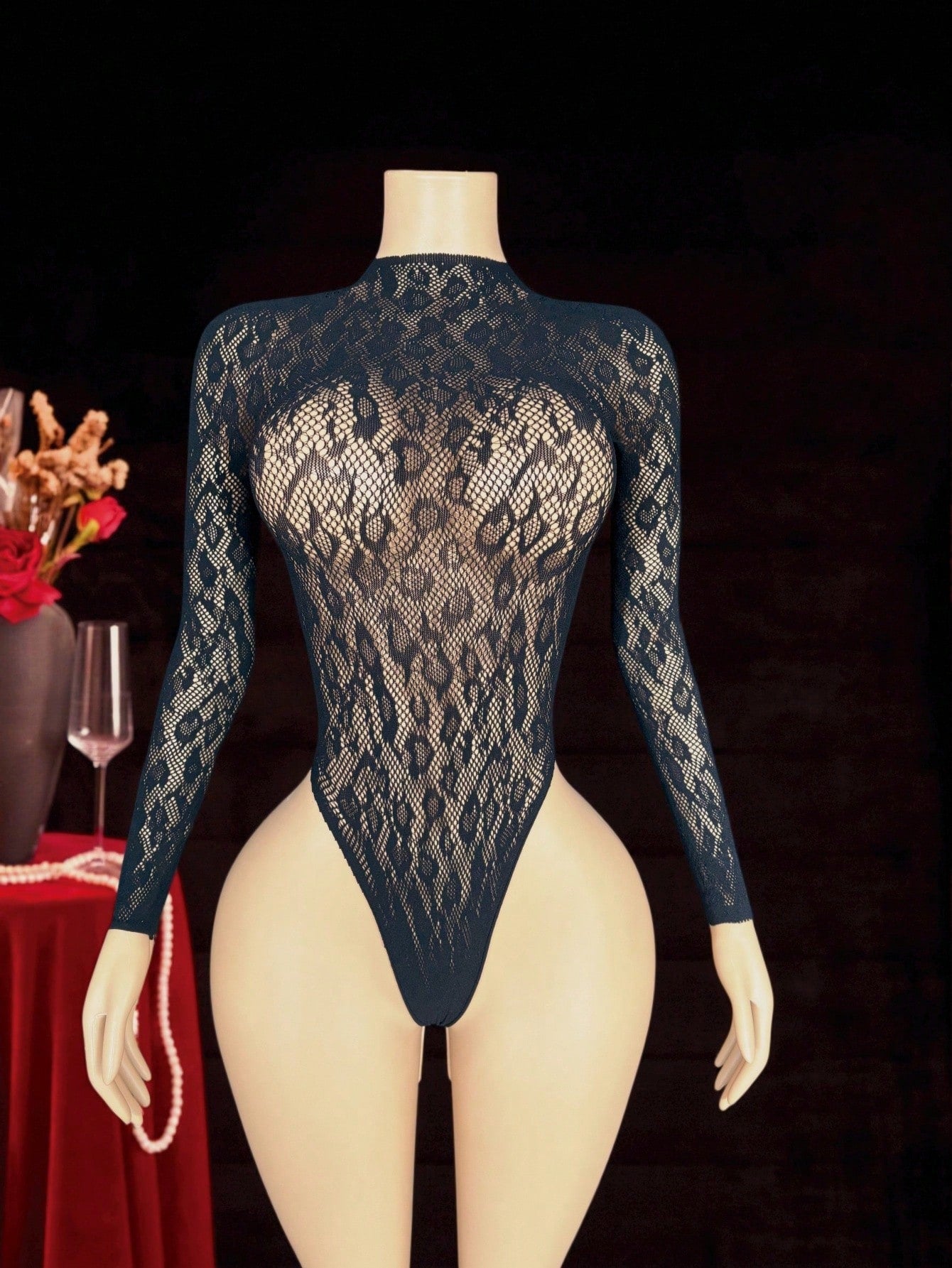 Women's black fishnet sheer bodysuit with adjustable straps, round neck, and high-stretch polyamide elastane fabric.