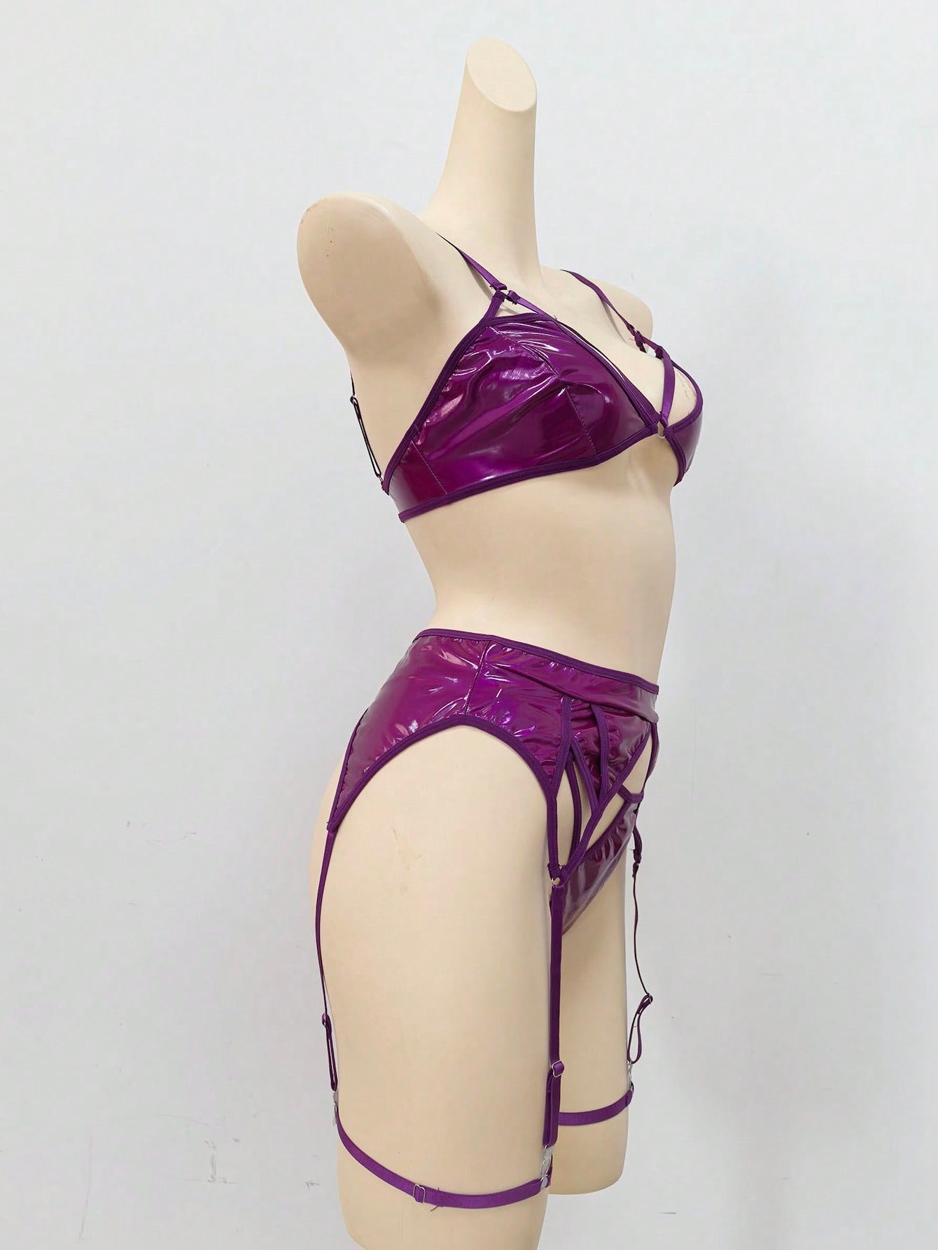 Women's 4-piece wireless lingerie set with cut-out bralette, adjustable spaghetti straps, V-string panty, and matching body accessories in plain style.