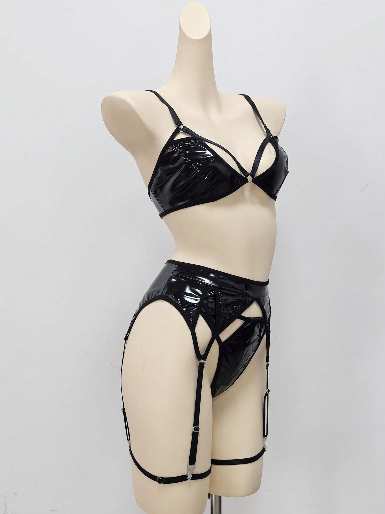 Women's 4-piece wireless lingerie set with cut-out bralette, adjustable spaghetti straps, V-string panty, and matching body accessories in plain style.