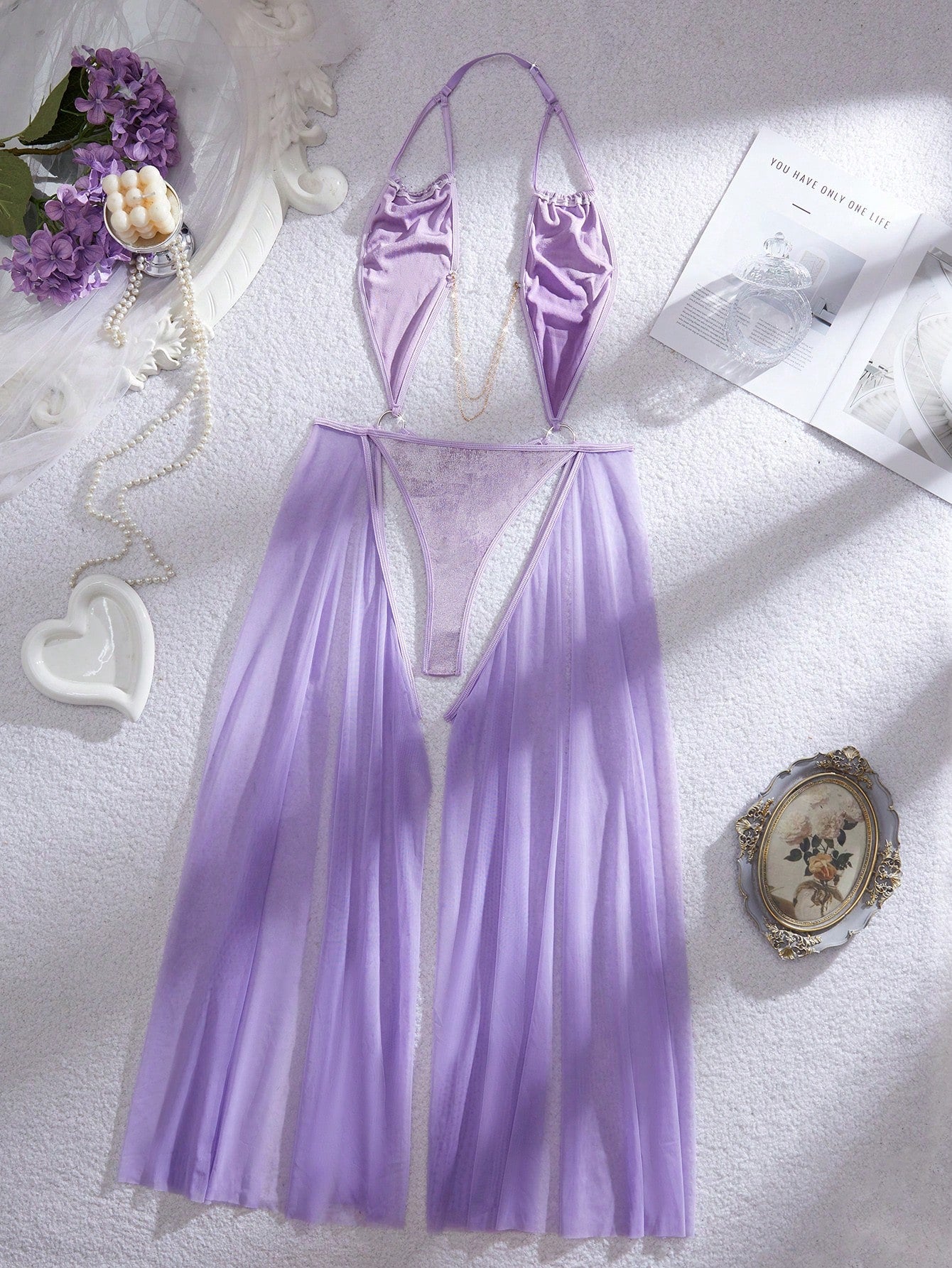 Women's halter lingerie slip dress in semi-sheer mesh with adjustable straps, backless cut-out design, chain detail, and wireless teddy-style fit.