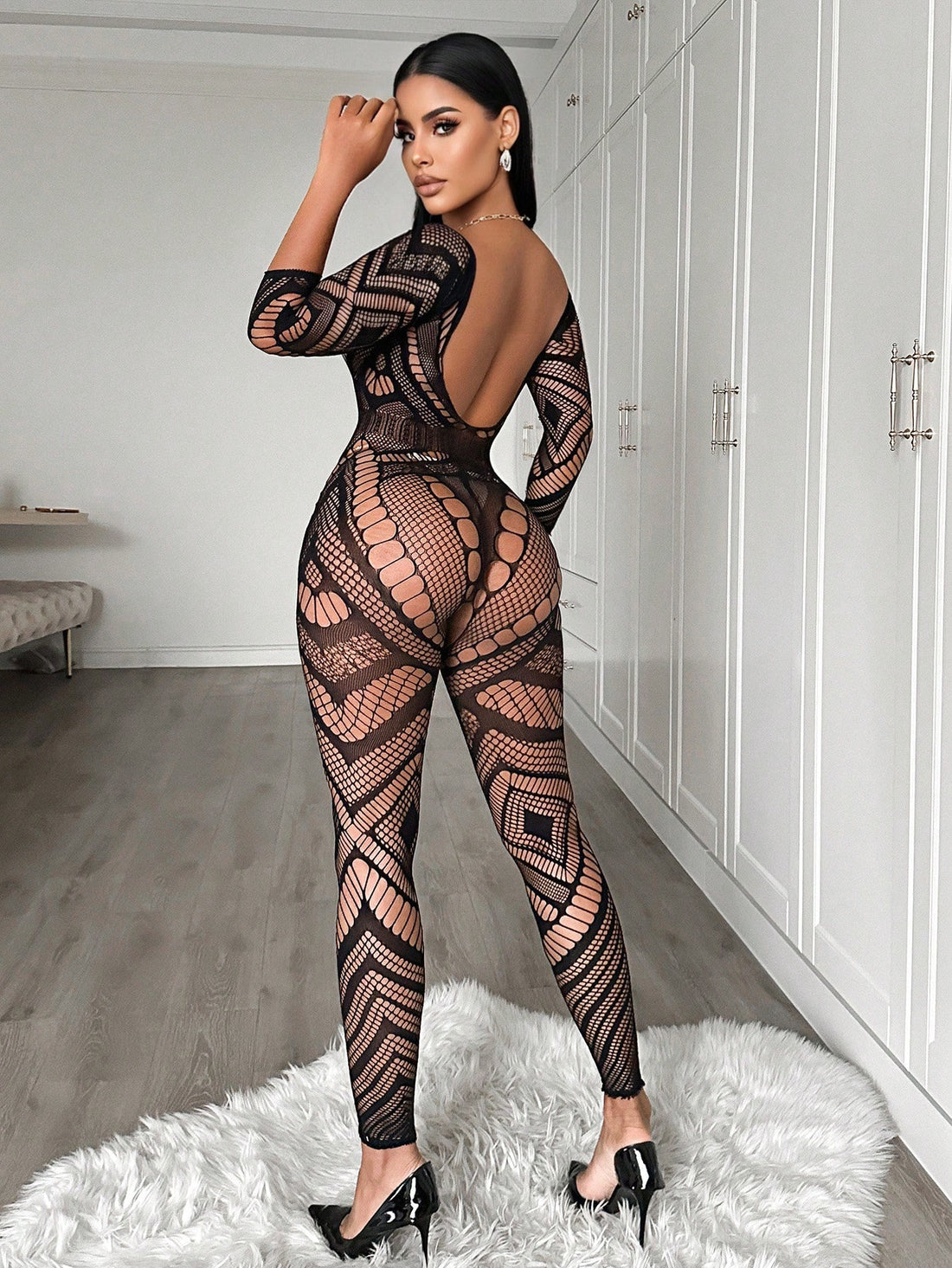 Women's black mesh bodysuit lingerie with hollow-out geometric design, plunge neckline, open back, adjustable straps, and three-quarter sleeves.