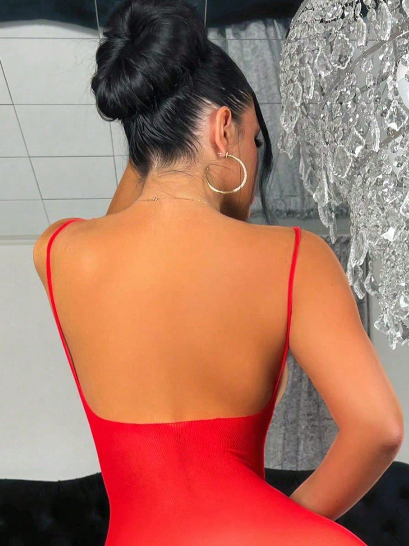Women's sheer backless lingerie slip dress with spaghetti straps, short length, and high-stretch knitted fabric.
