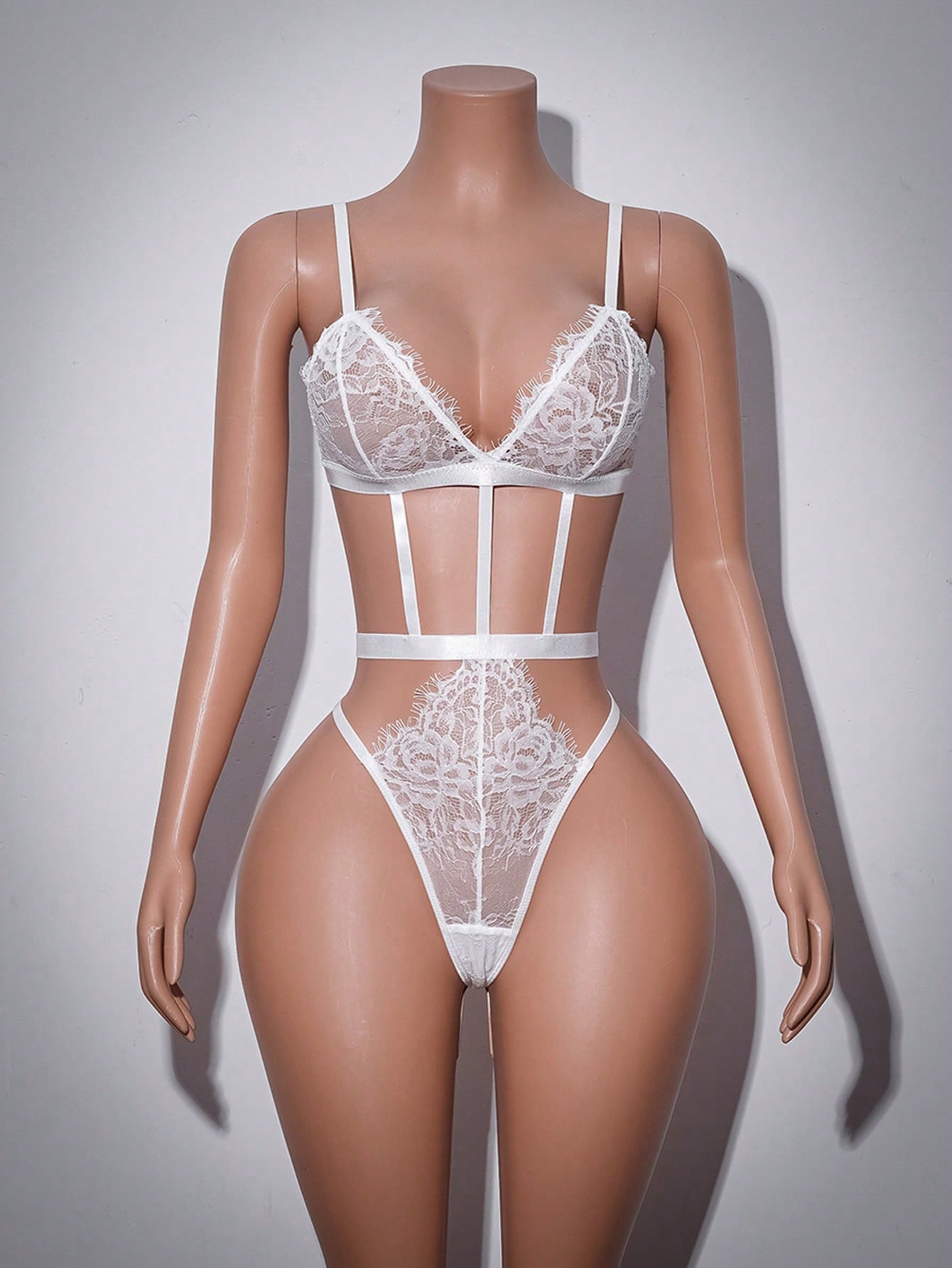 Women’s baby blue lace teddy bodysuit with sheer cut-out design, adjustable straps, V-neck, underwire triangle cups, and thong back.