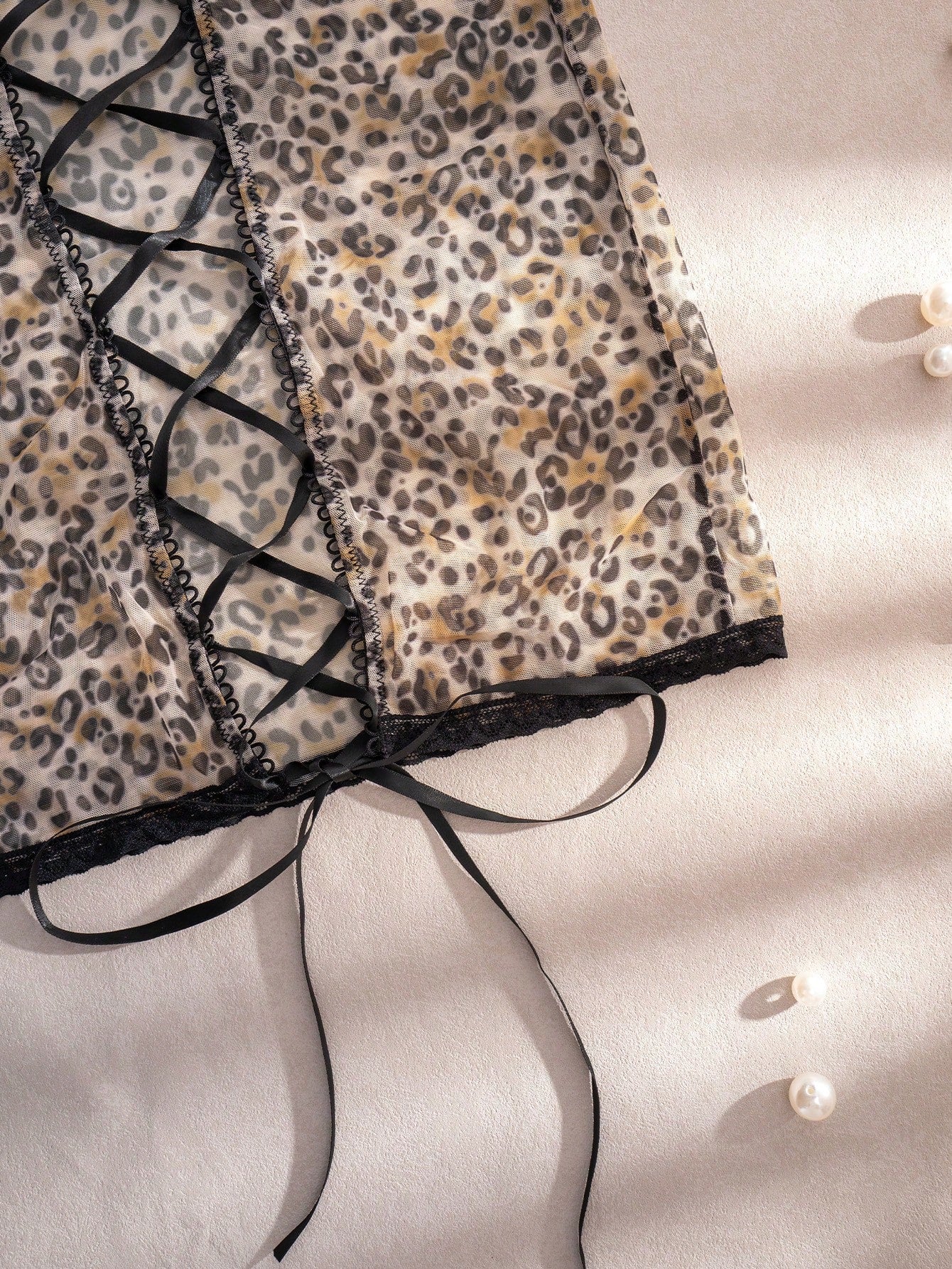 Women's leopard print semi-sheer mesh nightdress with backless tie-up design, criss cross cut out details, adjustable spaghetti straps, and wireless stretch fit.