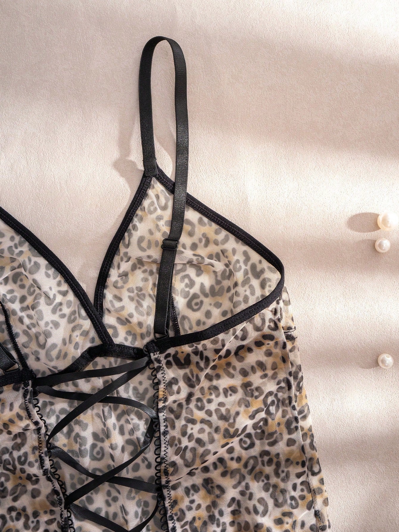 Women's leopard print semi-sheer mesh nightdress with backless tie-up design, criss cross cut out details, adjustable spaghetti straps, and wireless stretch fit.
