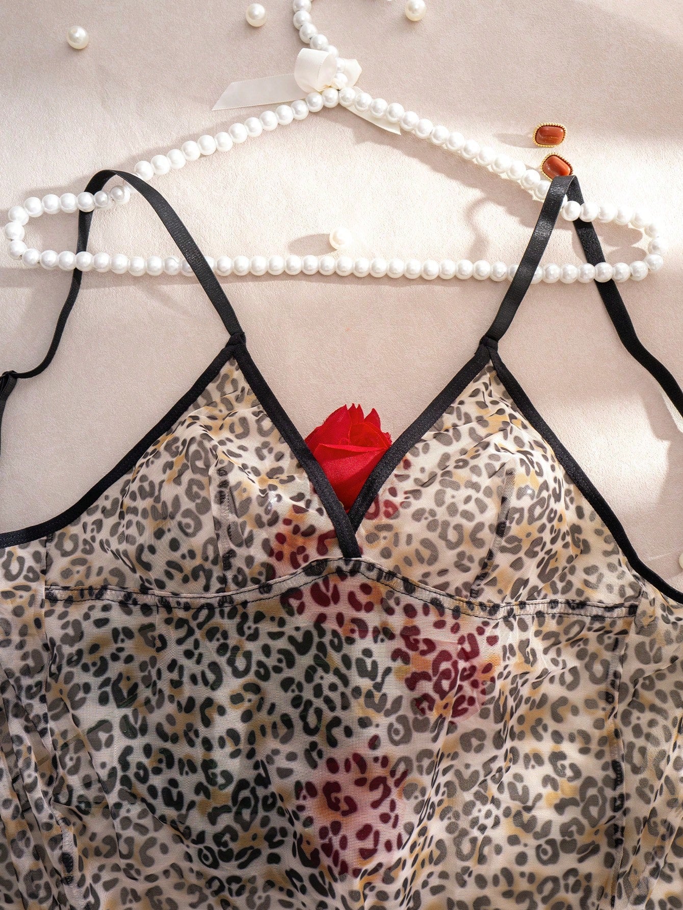 Women's leopard print semi-sheer mesh nightdress with backless tie-up design, criss cross cut out details, adjustable spaghetti straps, and wireless stretch fit.
