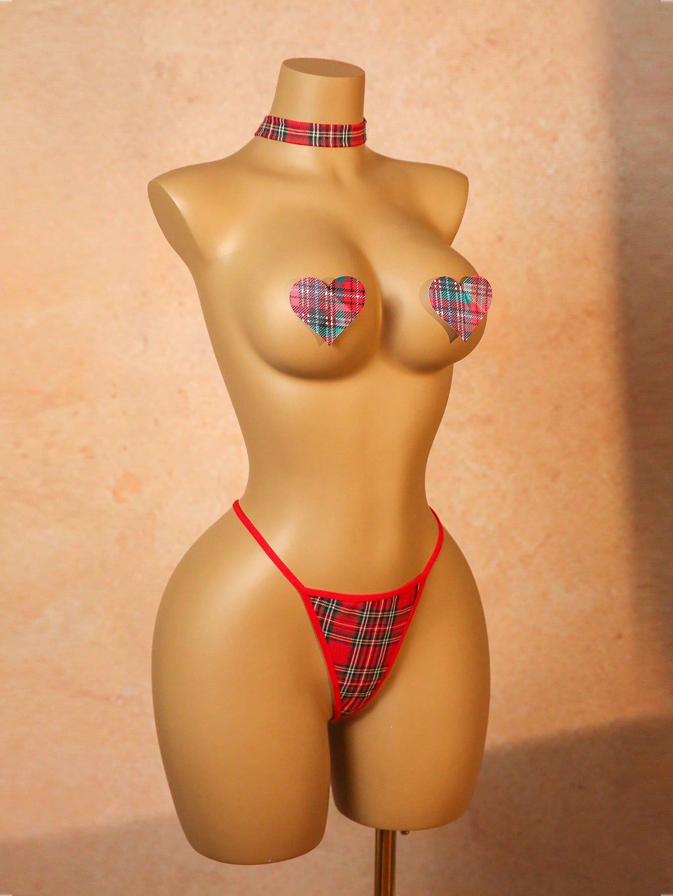 Women's red plaid 3-piece lingerie cosplay set with chest stickers, low-rise thong panties, and matching choker in polyester blend with adjustable straps and halter neckline.