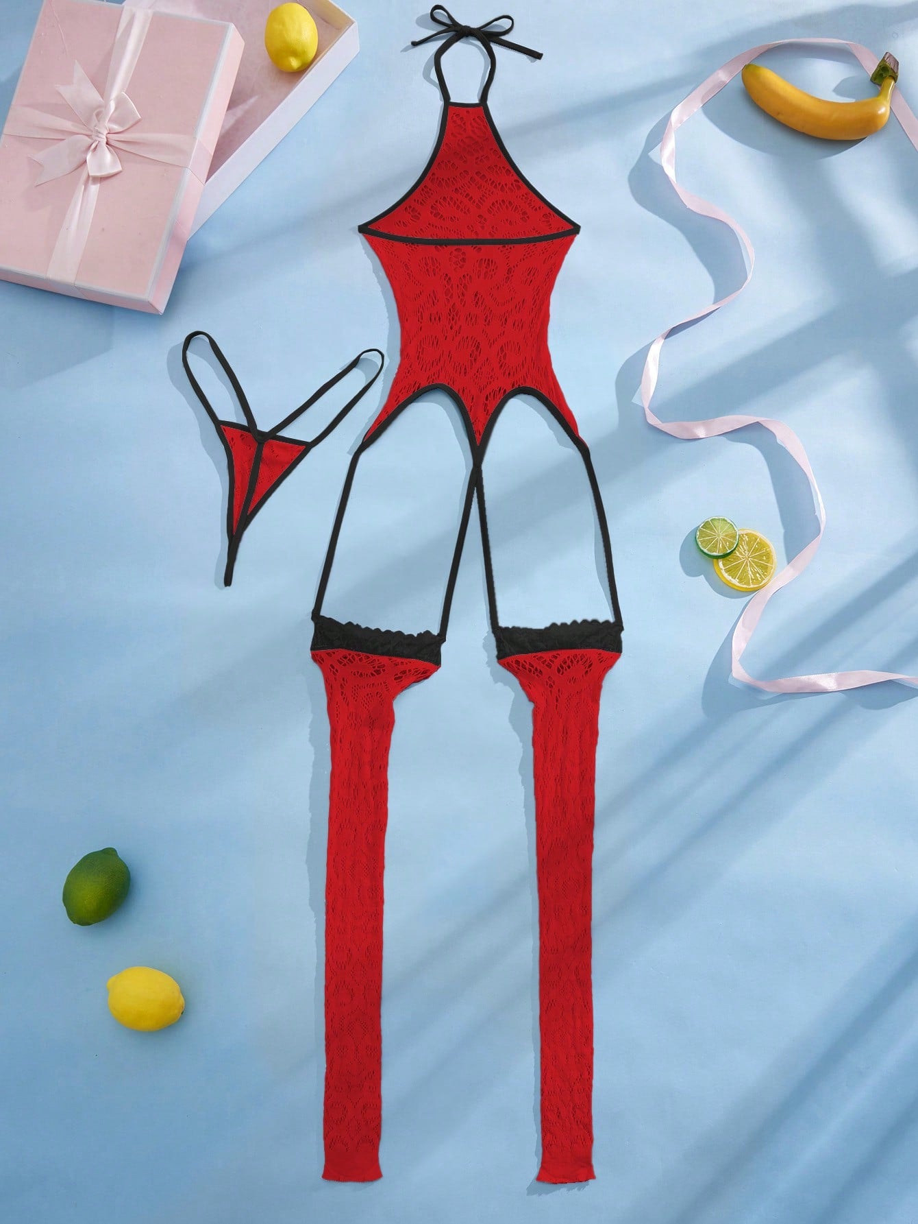 Women's semi-sheer mesh lingerie bodysuit set with halter neckline, backless design, hollow out details, bow accent, and thong styling in pink colorblock fabric.